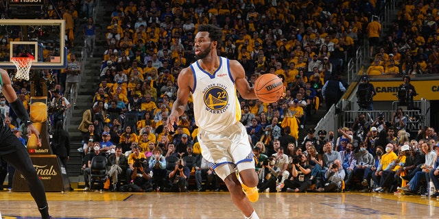 Andrew Wiggins #22 of the Golden State Warriors dribbles the ball against the Boston Celtics during Game Five of the 2022 NBA Finals on June 13, 2022 at Chase Center in San Francisco, California. 