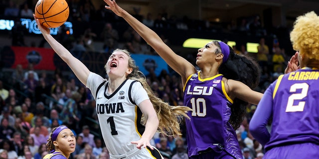 Iowa Hawkeyes guard Molly Davis drives to the basket against LSU Lady Tigers forward Angel Reese in the final round of the Women's Final Four NCAA tournament at the American Airlines Center in Dallas on April 2, 2023.