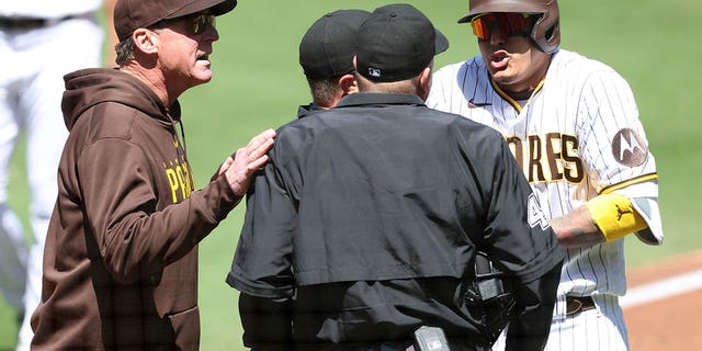 Manager Bob Melvin, left, argues with umpire Ron Kulpa after Manny Machado, right, of the San Diego Padres was called out on a timed third strike during the first inning of a game against the Arizona Diamondbacks at PETCO Park April 4, 2023, in San Diego. 