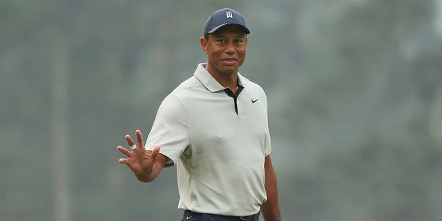 Tiger Woods of the United States waves on the third green during a practice round prior to the 2023 Masters Tournament at Augusta National Golf Club on April 04, 2023 in Augusta, Georgia.