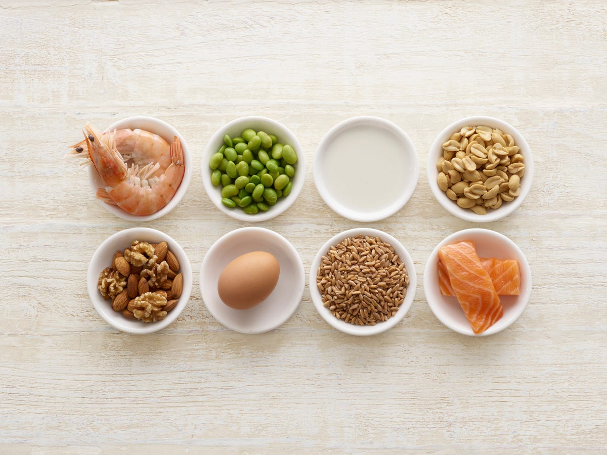 Small bowls filled with common food allergens like nuts, shrimp and eggs..