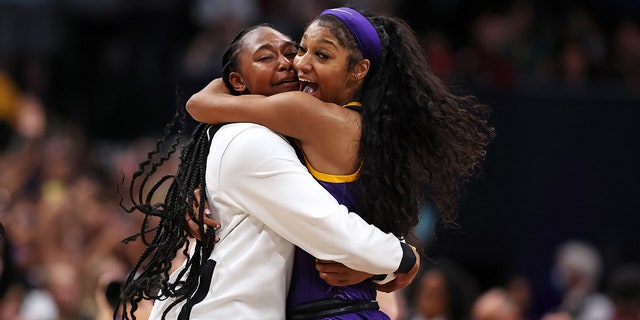 Angel Reese, #10 of the LSU Lady Tigers, celebrates with a teammate after defeating the Iowa Hawkeyes 102-85 during the 2023 NCAA Women's Basketball Tournament championship game at American Airlines Center on April 2, 2023 in Dallas.