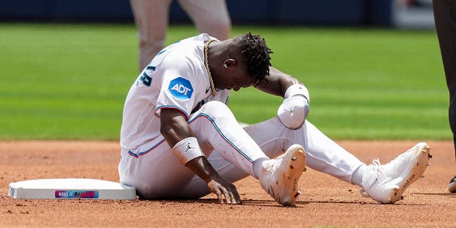 Jazz Chisholm Jr. of the Miami Marlins sits at second base after being thrown out attempting to steal during the first inning against the Minnesota Twins at loanDepot park April 5, 2023, in Miami, Fla. 