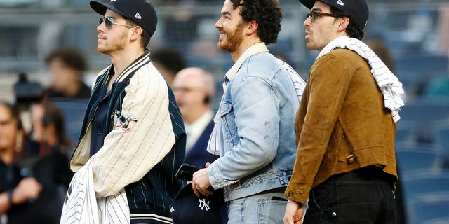 Nick Jonas, Kevin Jonas and Joe Jonas look on before the first inning between the New York Yankees and the Philadelphia Phillies at Yankee Stadium on April 4, 2023 in the Bronx borough of New York City.