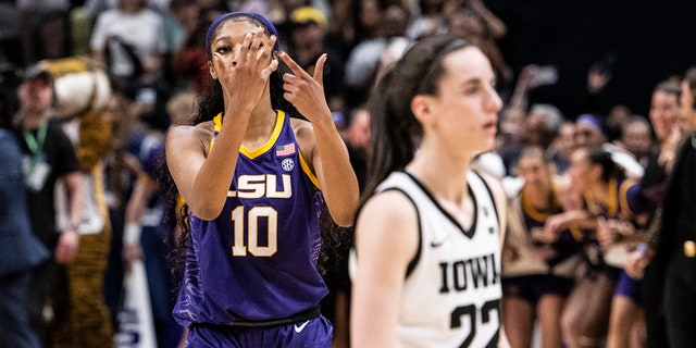 Angel Reese, #10 of the LSU Lady Tigers, reacts in front of Caitlin Clark, #22 of the Iowa Hawkeyes, towards the end of the 2023 NCAA Women's Basketball Tournament championship game at American Airlines Center on April 2, 2023 in Dallas.