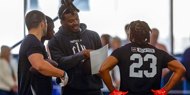 Former NFL and Auburn quarterback, Cam Newton, talks with receivers during Auburn Pro Day, Tuesday, March 21, 2023, in Auburn, Ala.