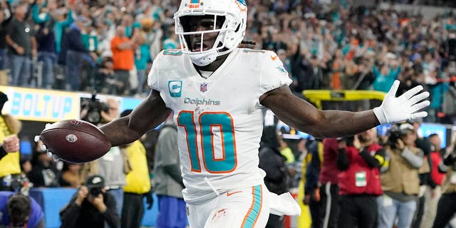 Miami Dolphins wide receiver Tyreek Hill scores a touchdown after recovering a fumble during the first half of a game against the Los Angeles Chargers Dec. 11, 2022, in Inglewood, Calif. 