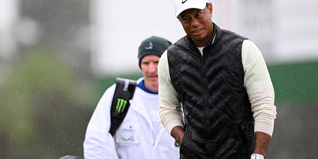 Tiger Woods of the United States looks on from the 18th green during the continuation of the weather delayed second round of the 2023 Masters Tournament at Augusta National Golf Club on April 8, 2023, in Augusta, Georgia.