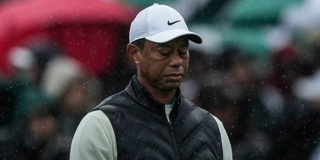 Tiger Woods walks on the 18th hole during the weather-delayed second round of the Masters on Saturday, April 8, 2023.