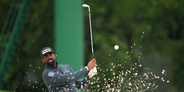 Sahith Theegala hits from the bunker on the 18th hole during the weather delayed second round of the Masters golf tournament at Augusta National Golf Club on Saturday, April 8, 2023, in Augusta, Ga.