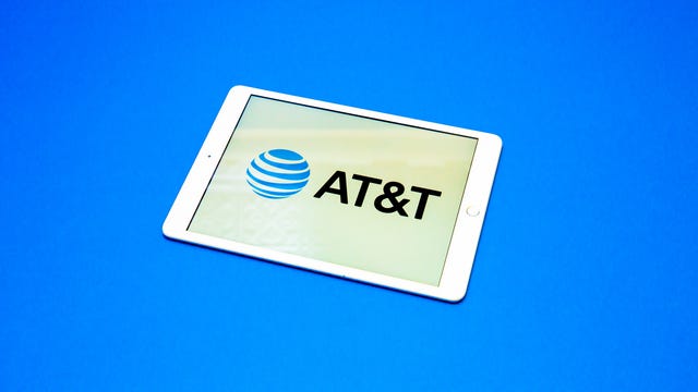 AT&T logo of blue earth with horizontal white lines on a tablet