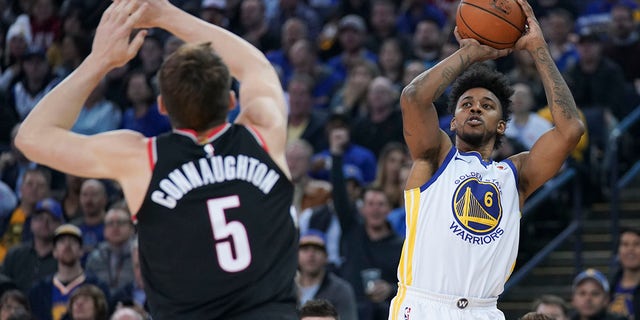 Golden State Warriors guard Nick Young shoots the basketball against Portland Trail Blazers guard Pat Connaughton at Oracle Arena on Dec. 11, 2017, in Oakland, California.