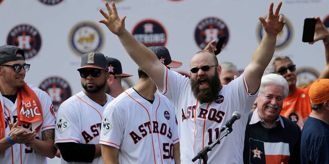 Evan Gattis #11 of the Houston Astros is introduced during the Houston Astros Victory Parade on November 3, 2017 in Houston, Texas.  The Astros defeated the Los Angeles Dodgers 5-1 in Game 7 to win the 2017 World Series.  