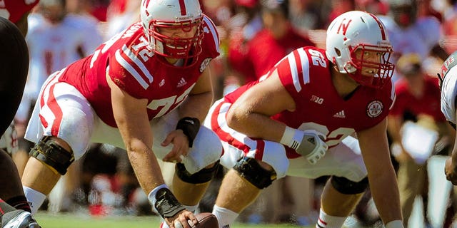 Nebraska offensive linemen Justin Jackson (72) and Cole Pensick (62) before snapping the ball against the Arkansas State Red Wolves at Memorial Stadium Sept. 15, 2012, in Lincoln, Neb.  