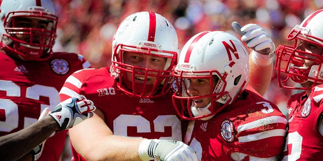 Quarterback Taylor Martinez (3) of the Nebraska Cornhuskers is congratulated by offensive lineman Cole Pensick (62) during a game at Memorial Stadium Sept. 15, 2012, in Lincoln, Neb.