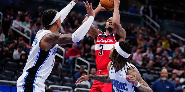 Mar 21, 2023; Orlando, Florida, USA; Washington Wizards guard Bradley Beal (3) shoots over Orlando Magic forward Paolo Banchero (5) during the second half  at Amway Center.