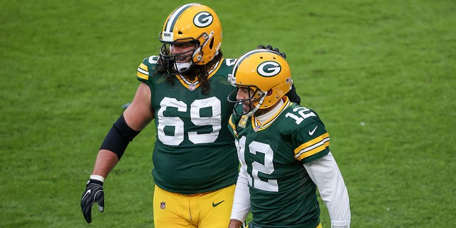 David Bakhtiari (69) and Aaron Rodgers (12) of the Green Bay Packers celebrate after scoring a touchdown in the second quarter against the Jacksonville Jaguars at Lambeau Field Nov. 15, 2020, in Green Bay, Wis.