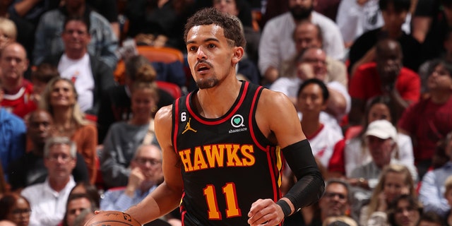 Trae Young #11 of the Atlanta Hawks dribbles the ball during the 2023 Play-In Tournament against the Miami Heat on April 11, 2023 at Kaseya Center in Miami, Florida.