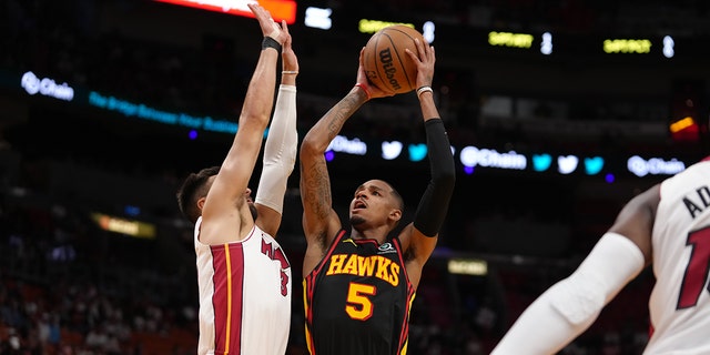 Dejounte Murray #5 of the Atlanta Hawks shoots the ball during the 2023 Play-In Tournament against the Miami Heat on April 11, 2023, at Kaseya Center in Miami, Florida. 