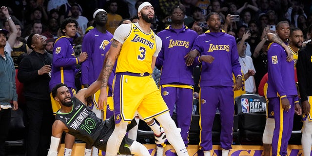 Minnesota Timberwolves guard Mike Conley is fouled, on a 3-point shot, by Lakers forward Anthony Davis during the play-in tournament game Tuesday, April 11, 2023, in Los Angeles.