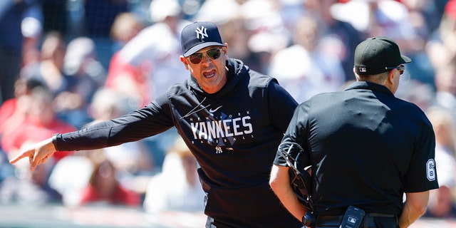 Aaron Boone #17 of the New York Yankees argues a review call with home plate umpire Chris Guccione #68 after being ejected from the game during the first inning at Progressive Field on April 12, 2023 in Cleveland, Ohio.