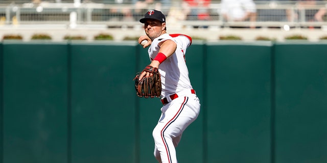 Kyle Farmer of the Minnesota Twins throws to first base to get out Andrew Vaughn of the Chicago White Sox in the eighth inning of a game at Target Field April 10, 2023, in Minneapolis.