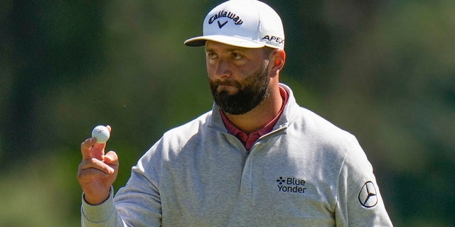 Jon Rahm, of Spain, waves after his putt on the third hole during the final round of the Masters golf tournament at Augusta National Golf Club on Sunday, April 9, 2023, in Augusta, Ga.