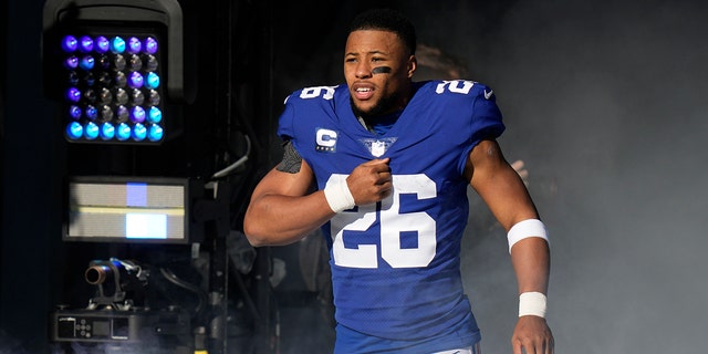 New York Giants running back Saquon Barkley reacts as he is introduced before a game against the Indianapolis Colts Jan. 1, 2023, in East Rutherford, N.J. 