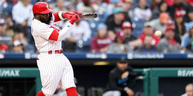 Josh Harrison #2 of the Philadelphia Phillies hits a single during the second inning against the Miami Marlins at Citizens Bank Park on April 11, 2023 in Philadelphia, Pennsylvania. 