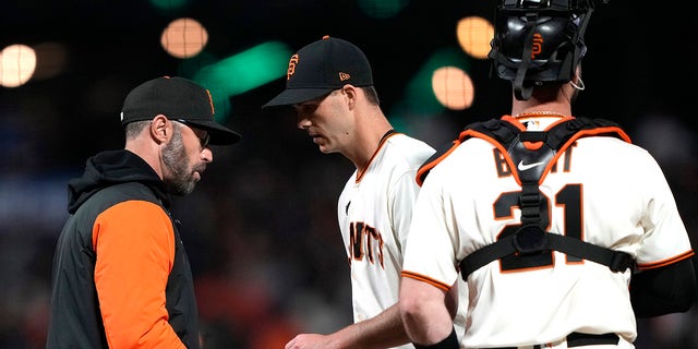 Giants manager Gabe Kapler takes the ball from Taylor Rogers, taking him out of the Los Angeles Dodgers game at Oracle Park on April 10, 2023, in San Francisco.