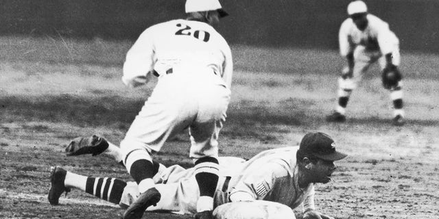 Babe Ruth is safe during a game between American and Japanese all-stars at Meiji Shire Grounds, Tokyo, Japan, Nov. 21, 1934.