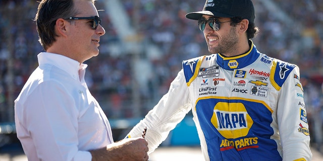 Chase Elliott and Jeff Gordon, vice chairman of Hendrick Motorsports, talk on the grid prior to the NASCAR Cup Series Championship at Phoenix Raceway on Nov. 6, 2022, in Avondale, Arizona.