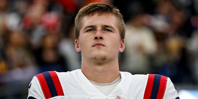 Bailey Zappe of the New England Patriots during the playing of the national anthem before the Raiders game at Allegiant Stadium on Dec. 18, 2022, in Las Vegas.