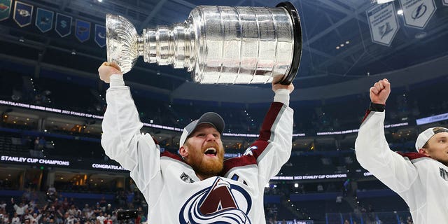 Gabriel Landeskog #92 of the Colorado Avalanche lifts the Stanley Cup after defeating the Tampa Bay Lightning 2-1 in Game Six of the 2022 NHL Stanley Cup Final at Amalie Arena on June 26, 2022 in Tampa, Florida.