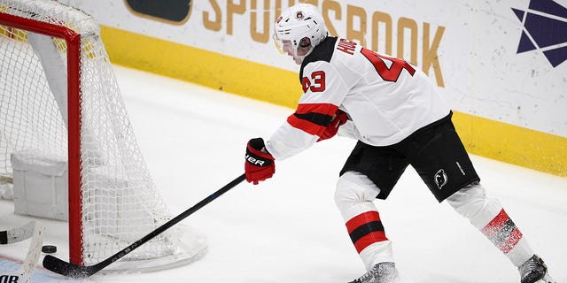 New Jersey Devils defenseman Luke Hughes scores the game-winning goal in overtime against the Washington Capitals, Thursday, April 13, 2023.