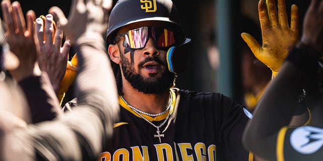 Fernando Tatis Jr., #23 of the San Diego Padres, celebrates in the dugout after hitting a home run during a spring training game against the Los Angeles Angels on March 24, 2023, at the Tempe Diablo Stadium in Tempe, Arizona.