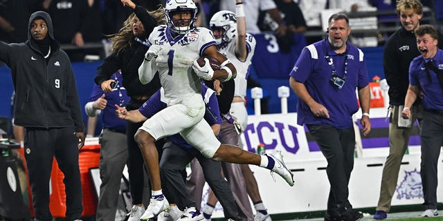 TCU Horned Frogs wide receiver Quentin Johnston runs with the ball in the game against the Michigan Wolverines during the Vrbo Fiesta Bowl at State Farm Stadium in Glendale, Arizona, on Dec. 31, 2022.