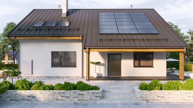 A home with rooftop solar panels and a back up battery.