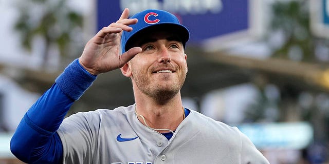 Chicago Cubs center fielder and former Los Angeles Dodger Cody Bellinger gestures to the crowd after being acknowledged by the Dodgers prior to a game Friday, April 14, 2023, in Los Angeles. 