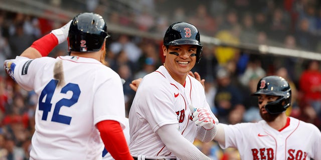 Red Sox's Yu Chang, center, is congratulated by teammates after hitting a two-run homer against the Los Angeles Angels at Fenway Park, Saturday, April 15, 2023, in Boston.