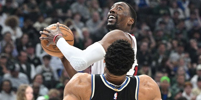 Apr 16, 2023; Milwaukee, Wisconsin, USA; Miami Heat center Bam Adebayo (13) drives against Milwaukee Bucks forward Giannis Antetokounmpo (34) in the first half during game one of the 2023 NBA Playoffs at Fiserv Forum.