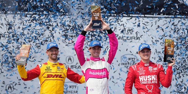 Winner Kyle Kirkwood, center, celebrates with second-place Romain Grosjean, left, of Switzerland, and third-place Marcus Ericsson during the victory ceremony for the IndyCar Grand Prix of Long Beach auto race Sunday, April 16, 2023, in Long Beach, Calif. 