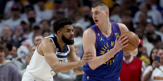 Nikola Jokic #15 of the Denver Nuggets is guarded by Karl-Anthony Towns #32 of the Minnesota Timberwolves in the first quarter during Round 1 Game 1 of the NBA Playoffs at Ball Arena on April 16, 2023 in Denver, Colorado. 