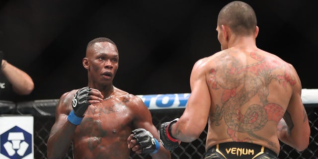 Israel Adesanya, left, battles Alex Pereira battles in their middleweight fight during the UFC 287 event on April 8, 2023, at the Kaseya Center in Miami.