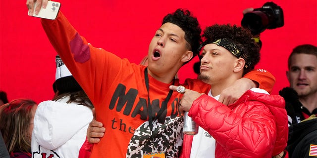 Jackson Mahomes and Patrick Mahomes #15 of the Kansas City Chiefs celebrate on stage during the Kansas City Chiefs Super Bowl LVII victory parade on February 15, 2023 in Kansas City, Missouri.