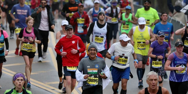 Runners arrive at the top of Heartbreak Hill during the 127th Boston Marathon. 