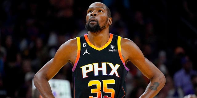 Phoenix Suns forward Kevin Durant (35) looks at the scoreboard during the first half of Game 2 of a first-round NBA basketball playoff series against the Los Angeles Clippers, Tuesday, April 18, 2023, in Phoenix. 