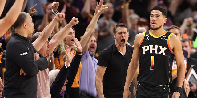 Devin Booker #1 of the Phoenix Suns reacts after hitting a three-point shot against the LA Clippers during the first half of Game Two of the Western Conference First Round Playoffs at Footprint Center on April 18, 2023, in Phoenix, Arizona.