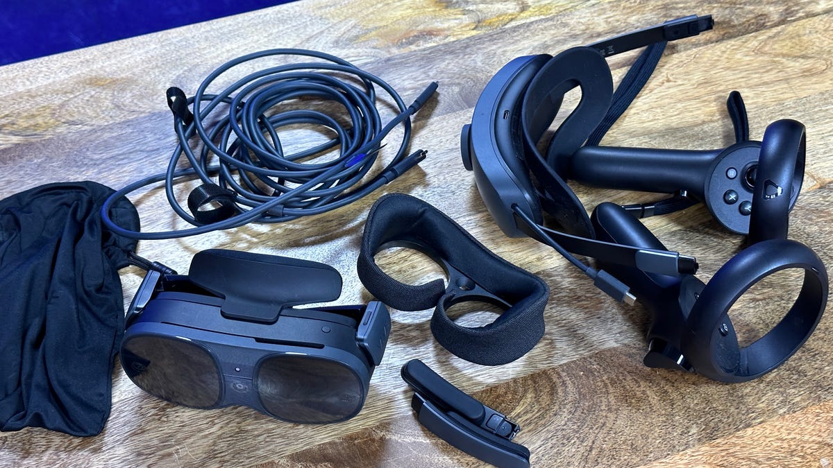 A bunch of VR accessories on a wooden table