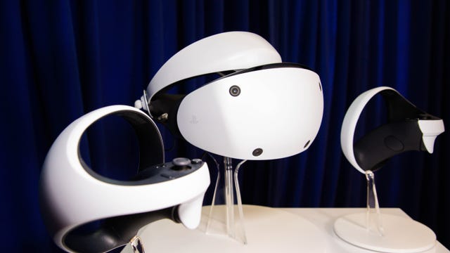 Sony PlayStation VR 2 virtual reality headset and controllers on stands